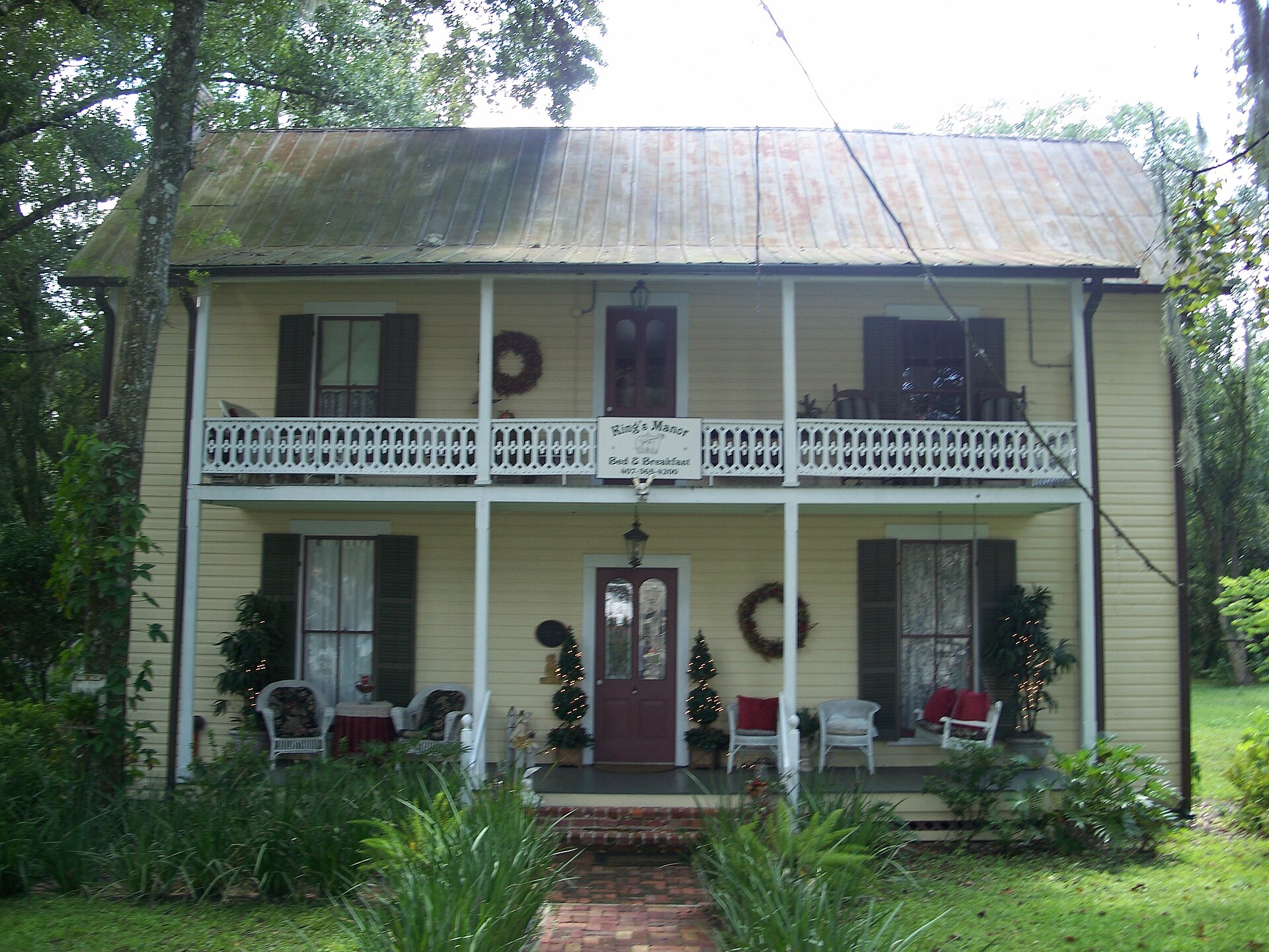 The Browne-King House, a historic wood-frame home in downtown Oviedo, under live oaks.
