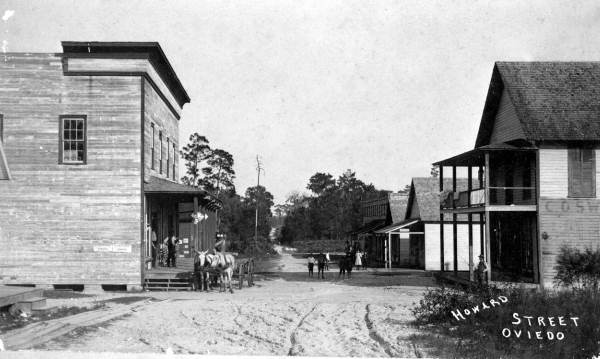 Howard Street, Oviedo, around 1900: a dirt road lined with wood-frame stores.