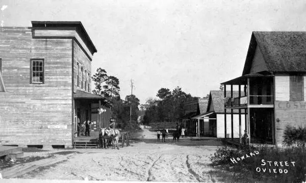 Howard Street, Oviedo, around 1900: a dirt road lined with wood-frame stores.